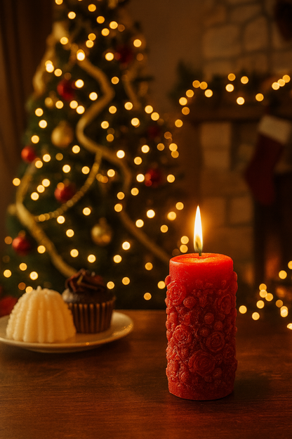Red candle on a table with a decorated Christmas tree in the background